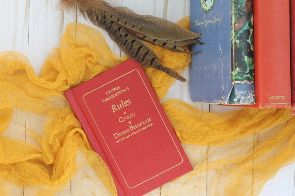 vintage books with pheasant feathers