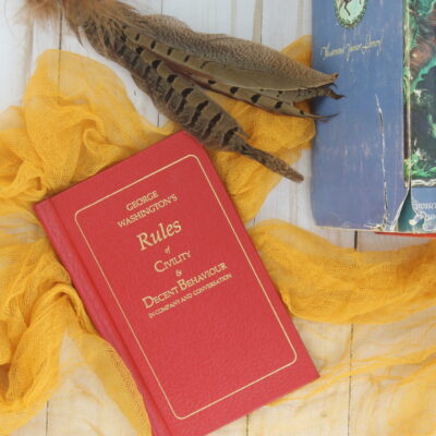 vintage books with pheasant feathers